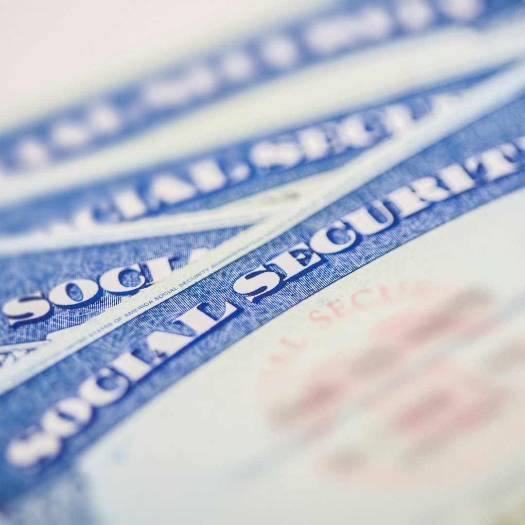 Close-up image of several U.S. Social Security cards stacked together.