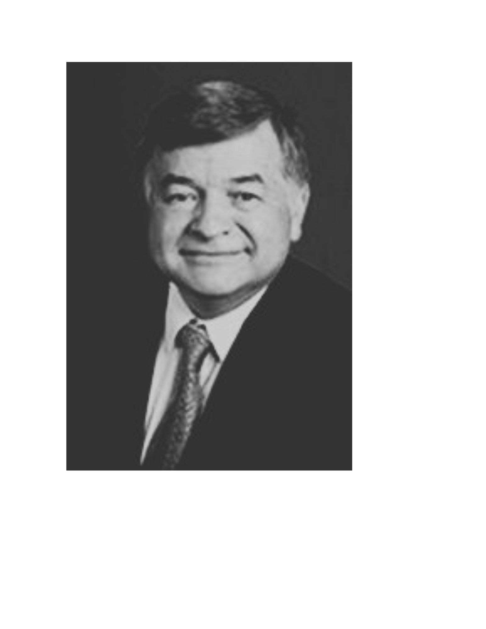 May contain: portrait, photography, head, face, person, tie, formal wear, accessories, smile, happy, suit, clothing, and necktie