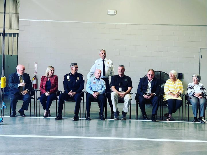 May contain: groupshot, person, adult, male, man, clothing, coat, people, crowd, footwear, and shoe