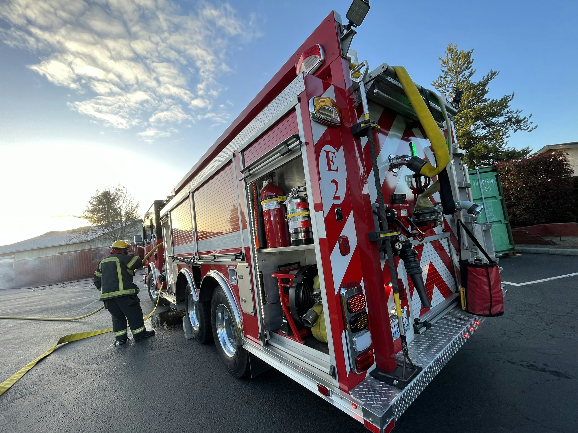 May contain: helmet, person, clothing, footwear, shoe, fire truck, transportation, truck, and vehicle