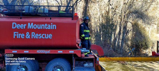 A firefighter on a Deer Mountain Fire & Rescue truck.