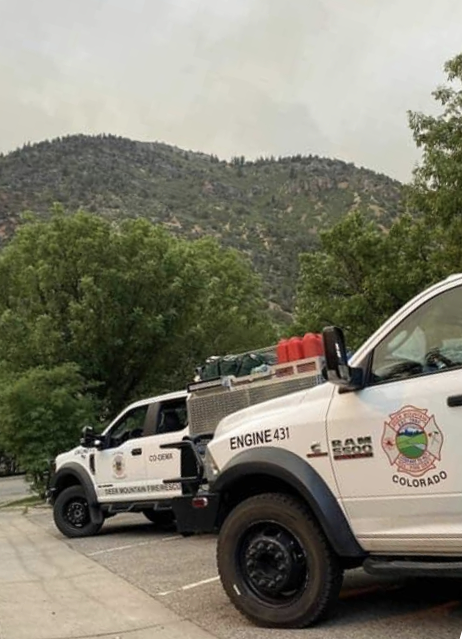 Two firefighting trucks marked "ENGINE 431" with a mountainous background.