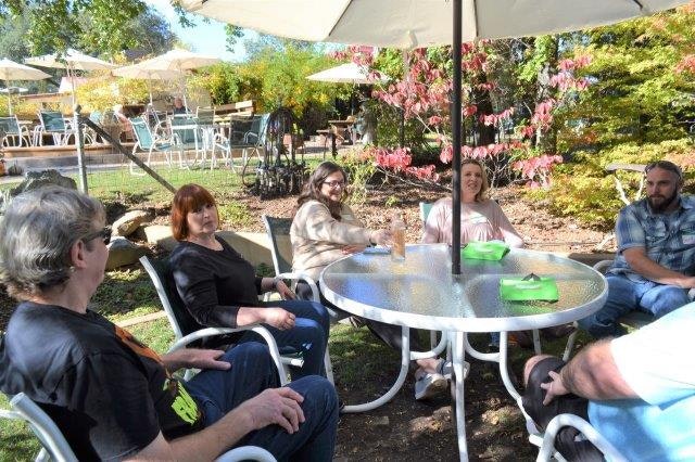 May contain: chair, furniture, person, human, yard, outdoors, nature, and table