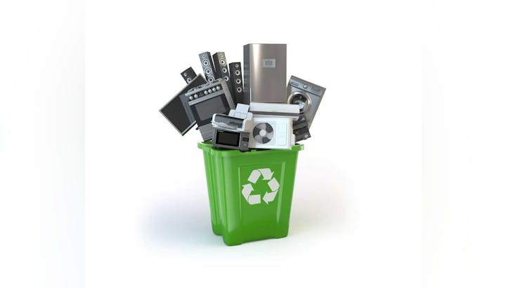 A green recycling bin overflowing with various electronic devices suggesting e-waste recycling.