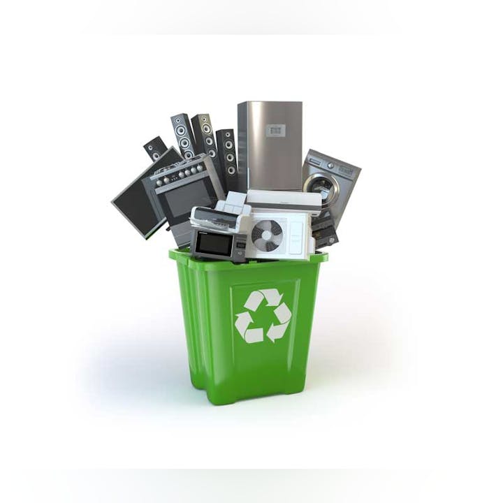 A green recycling bin overflowing with various electronic devices suggesting e-waste recycling.