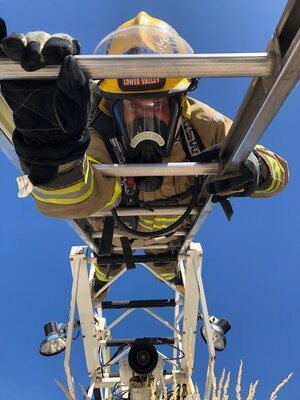 May contain: ladder, firefighter