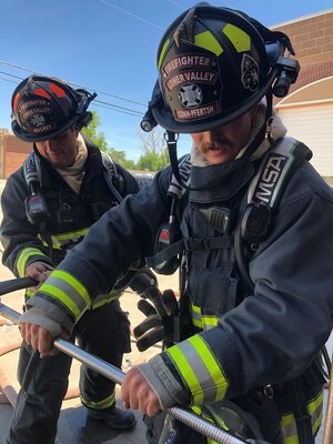 May contain: helmet, clothing, apparel, person, human, and fireman