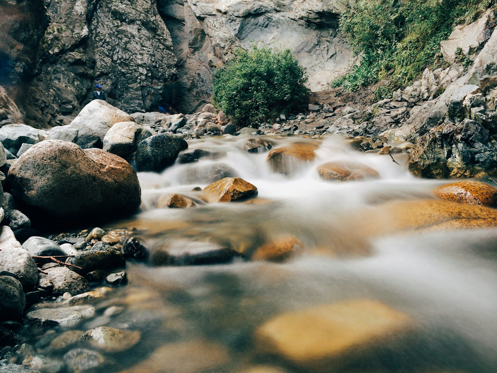 May contain: nature, outdoors, water, stream, rock, creek, and person