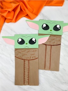 Yoda craft made with a small brown paper bag and green construction paper