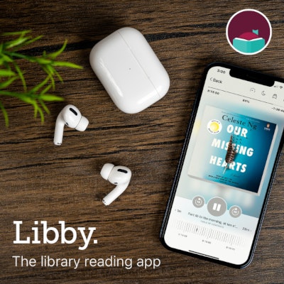 The image shows a phone displaying the Libby app with an audiobook, AirPods, and a wooden surface.