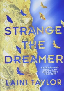 The cover of the book "Strange the Dreamer" by Laini Taylor. The cover is blue and gold with moths flying