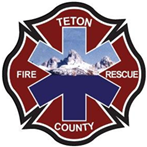 A badge with a mountain, cross, and text "TETON FIRE RESCUE COUNTY."