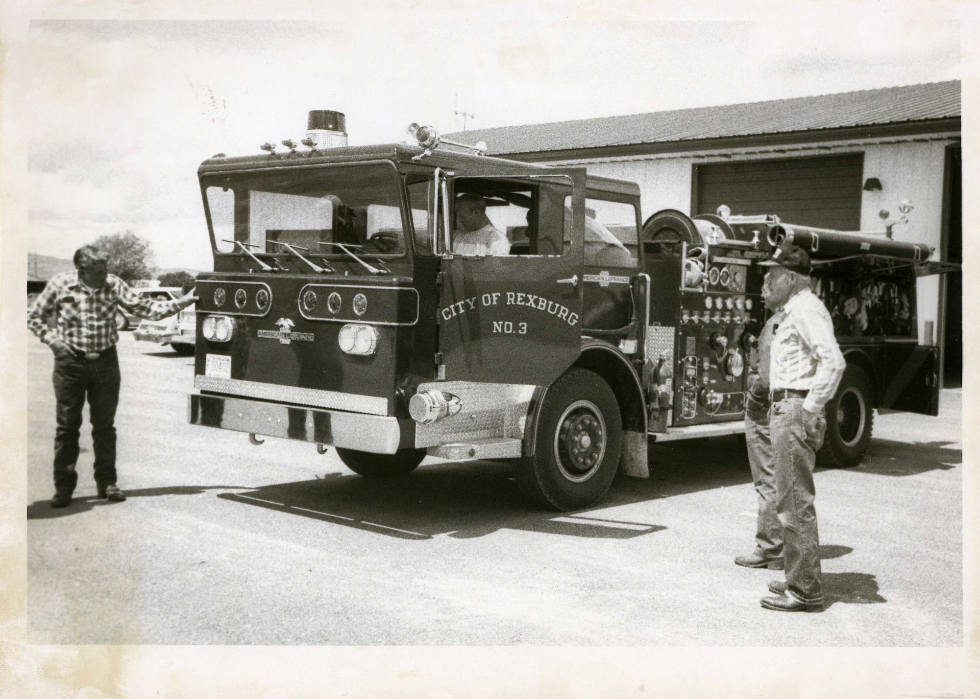 Vintage photo of two men and a fire engine labeled "CITY OF REXBURG NO.3."