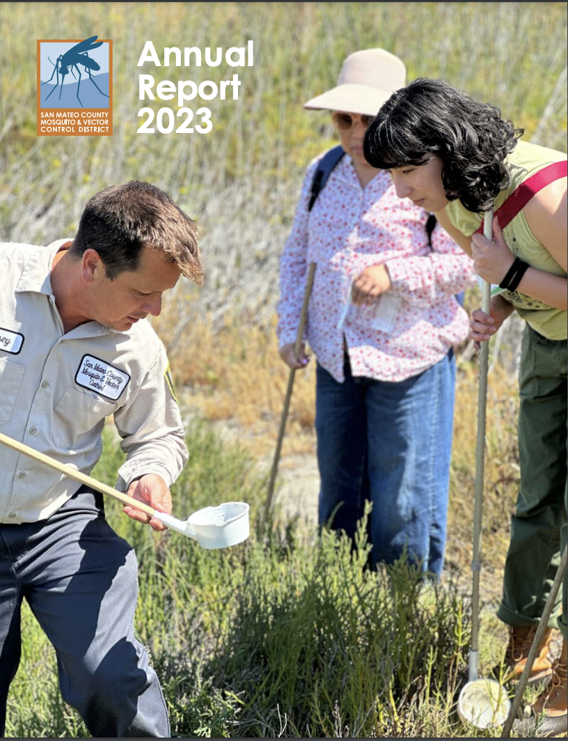 Three people looking at a mosquito dipper (a small white cup on the end of a wooden stick) while outdoors in a marsh, text "Annual Report 2023", and a logo - San Mateo County Mosquito & Vector Control District.