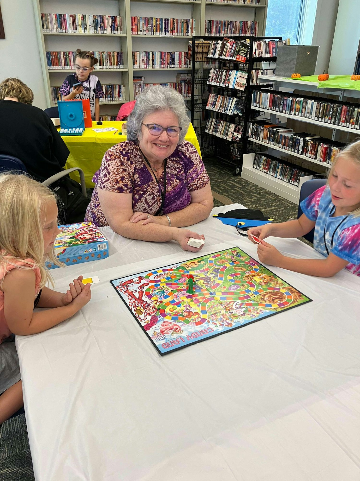 People playing a board game in a library.