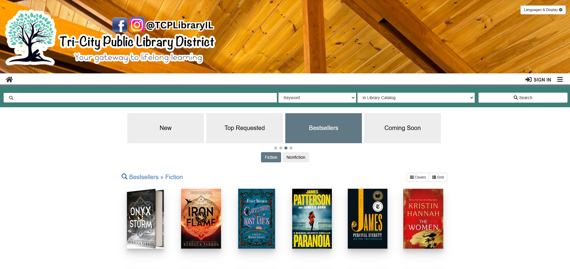 Library website featuring bestsellers: "Onyx Storm," "Iron Flame," "Compendium of Lost Tales," "Paranoia," "James," and "The Women."