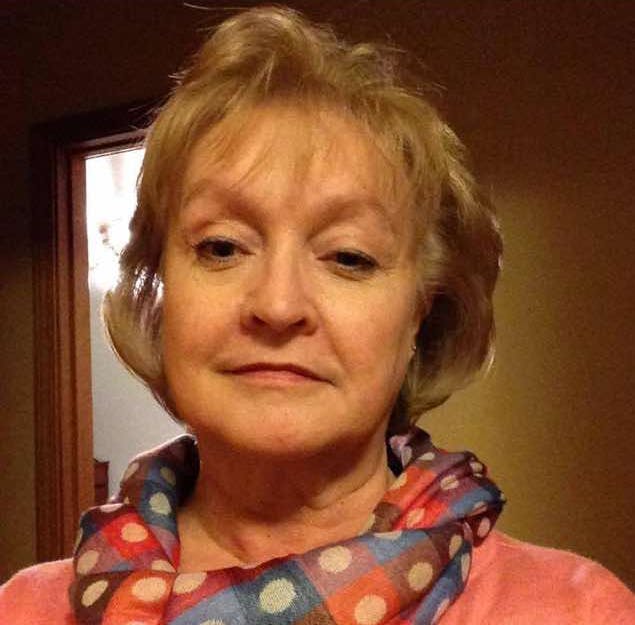 A woman with a scarf indoors.