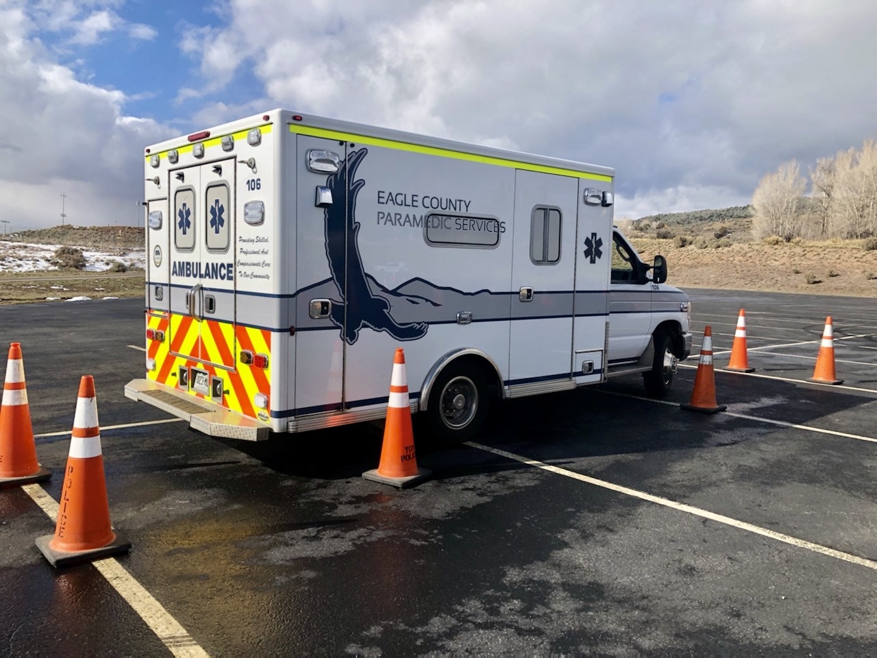 An ambulance from Eagle County Paramedic Services is parked with traffic cones around it.