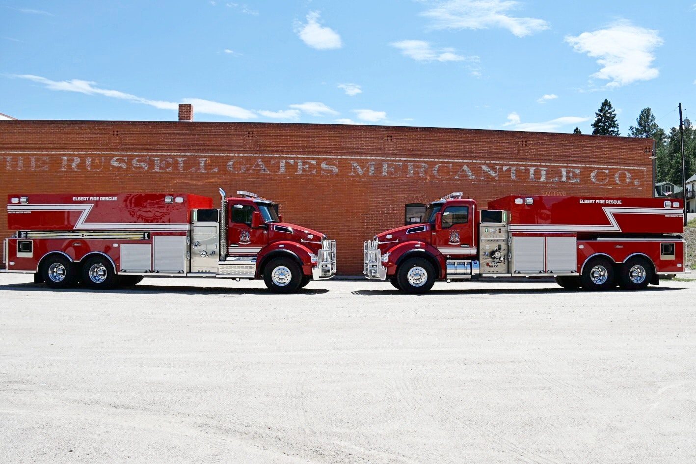 The image shows two red fire rescue trucks parked in front of a brick building with the text "RUSSELL GATES MERCANTILE CO."
