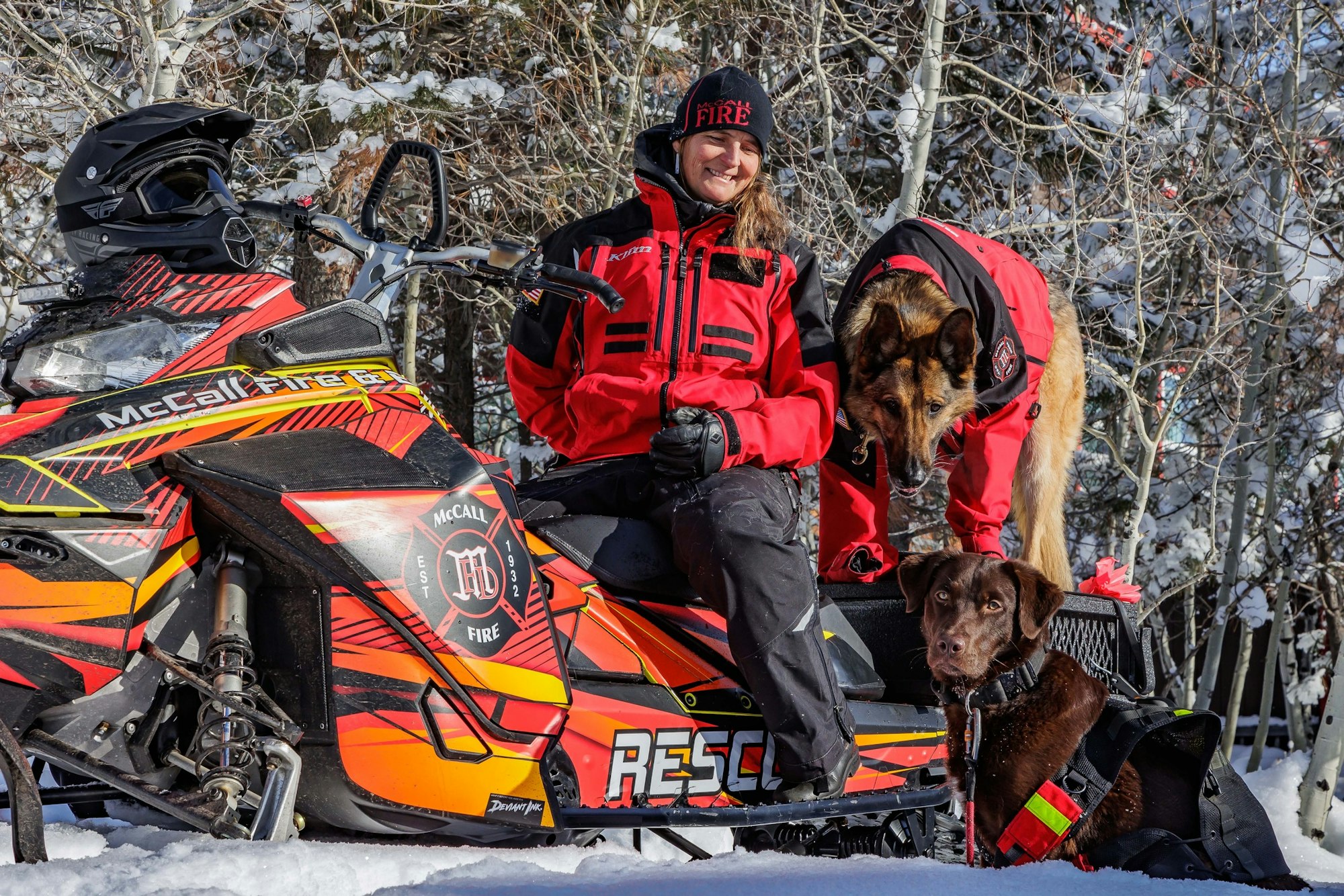 May contain: clothing, glove, nature, outdoors, helmet, person, footwear, shoe, snow, animal, canine, dog, mammal, and pet