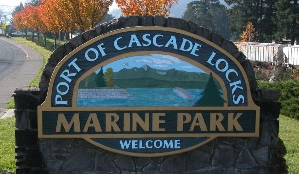 Sign for "Port of Cascade Locks Marine Park" with a scenic backdrop.