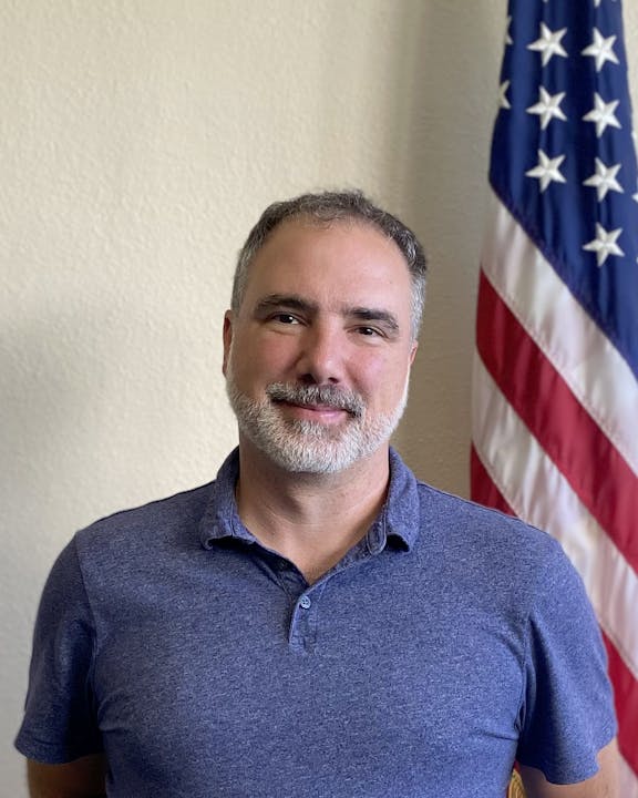 May contain: american flag, flag, adult, male, man, person, face, and head