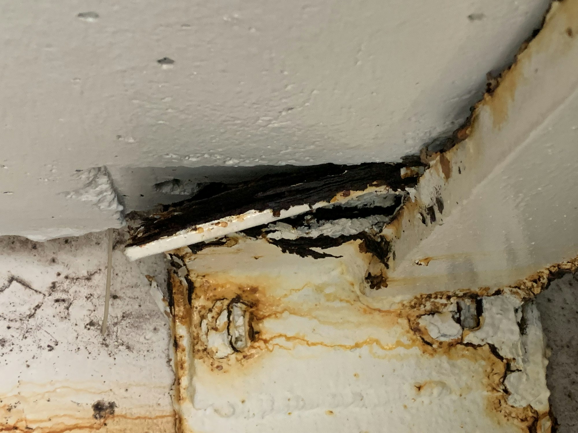 Rust and corrosion on metal surfaces with peeling paint.