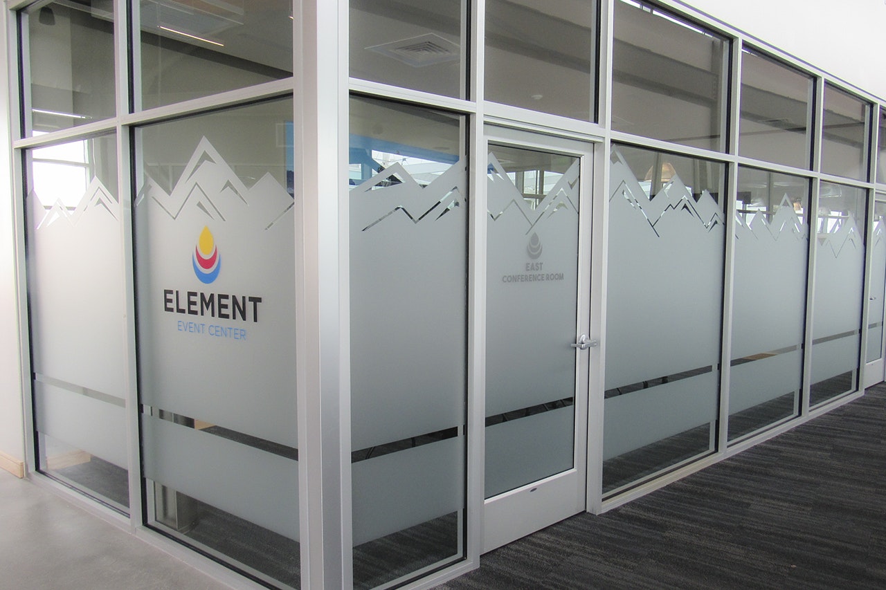 Glass-walled conference room with frosted glass decals, labeled "ELEMENT EVENT CENTER" on the door.