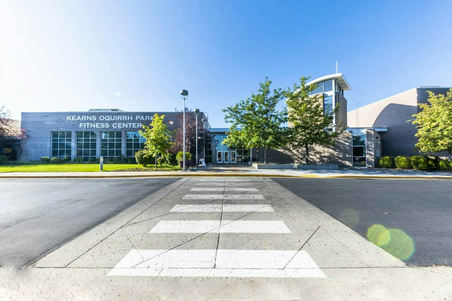 A fitness center building with a pedestrian crossing in the foreground.