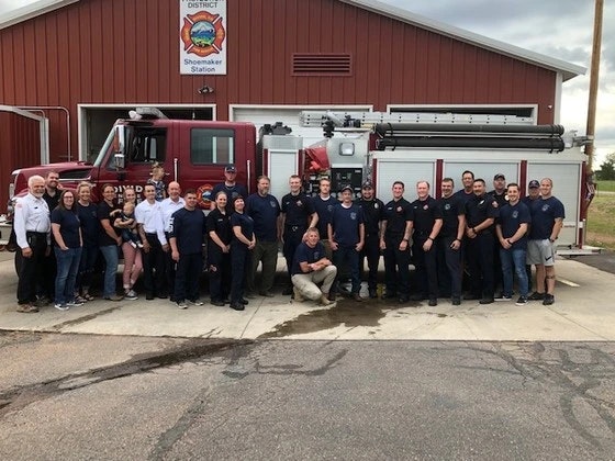 May Contain- Fire truck with members standing next to it