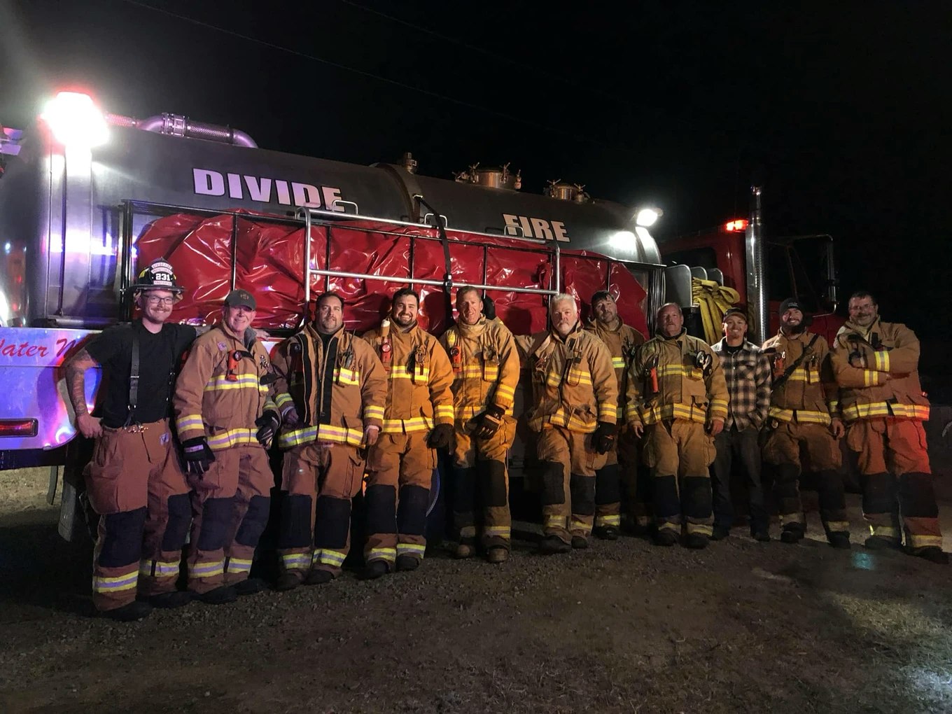 May Contain- Fire fighters standing next to fire truck