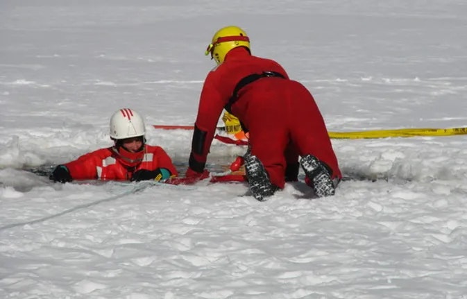 Staff pulling another Staff member out of the snow