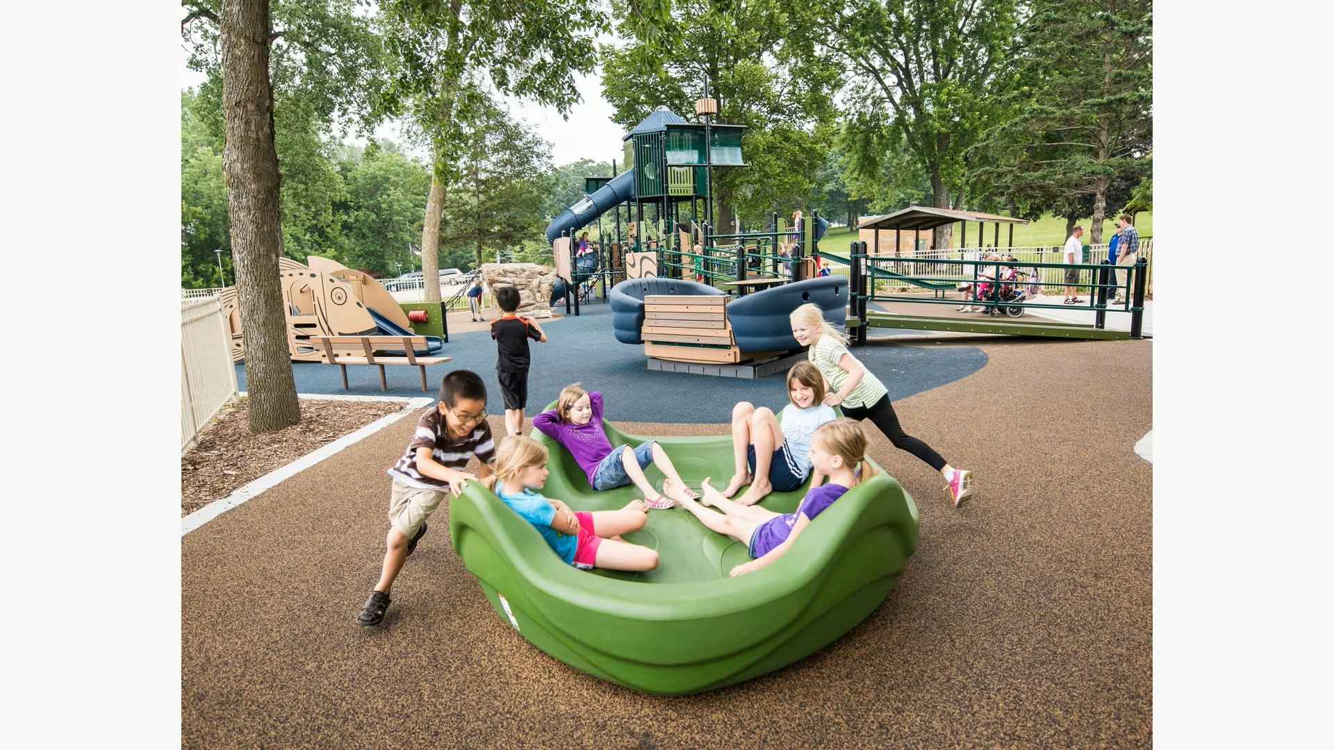 Children playing at a colorful playground, enjoying a green play structure and engaging in various activities together.
