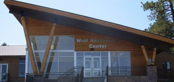 A building labeled "Wulf Recreation Center" with large angled wooden beams and stairs leading to the entrance.