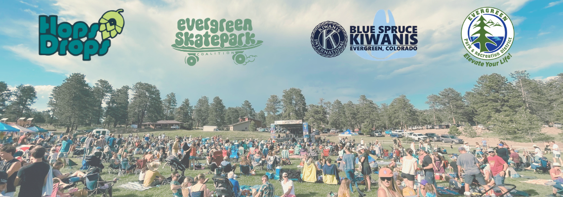 Outdoor event with a large crowd on a grassy area, surrounded by trees. Logos: Hop Drops, Evergreen Skatepark, Blue Spruce Kiwanis, Evergreen.