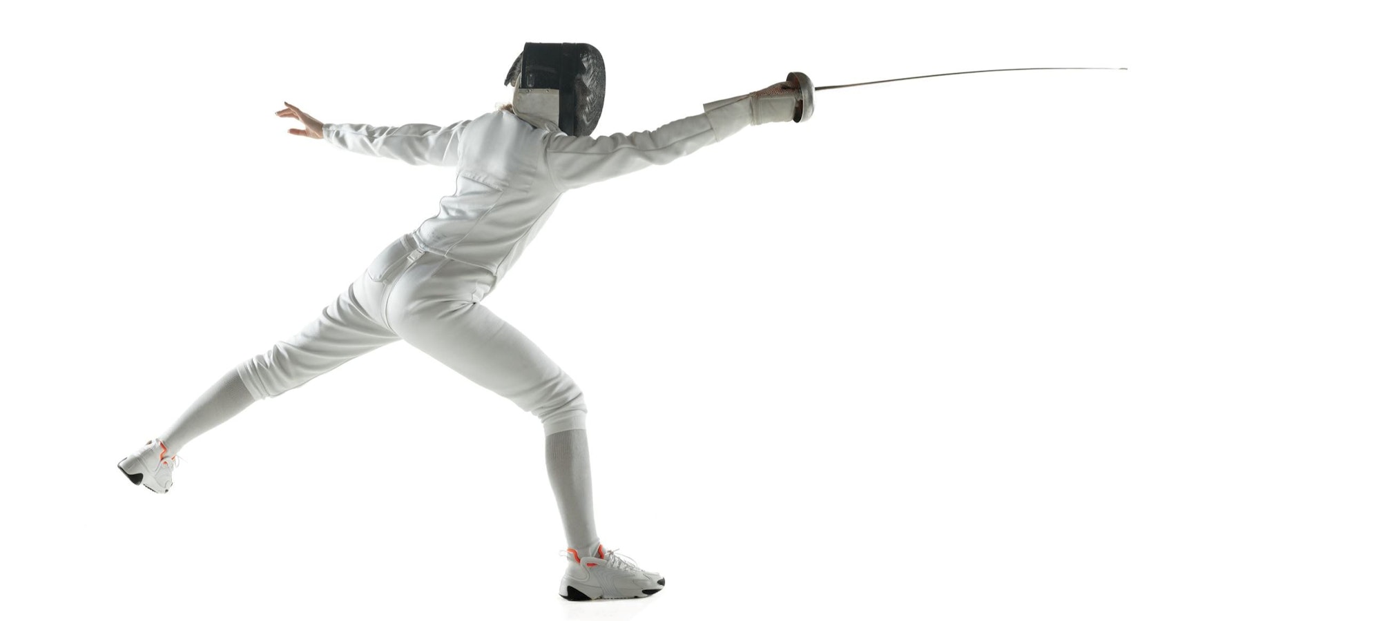 A fencer in a lunge pose with a foil, wearing protective gear on a white background.