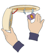 The image shows hands assembling or repairing a device, possibly involving components like a circular frame and a small part.