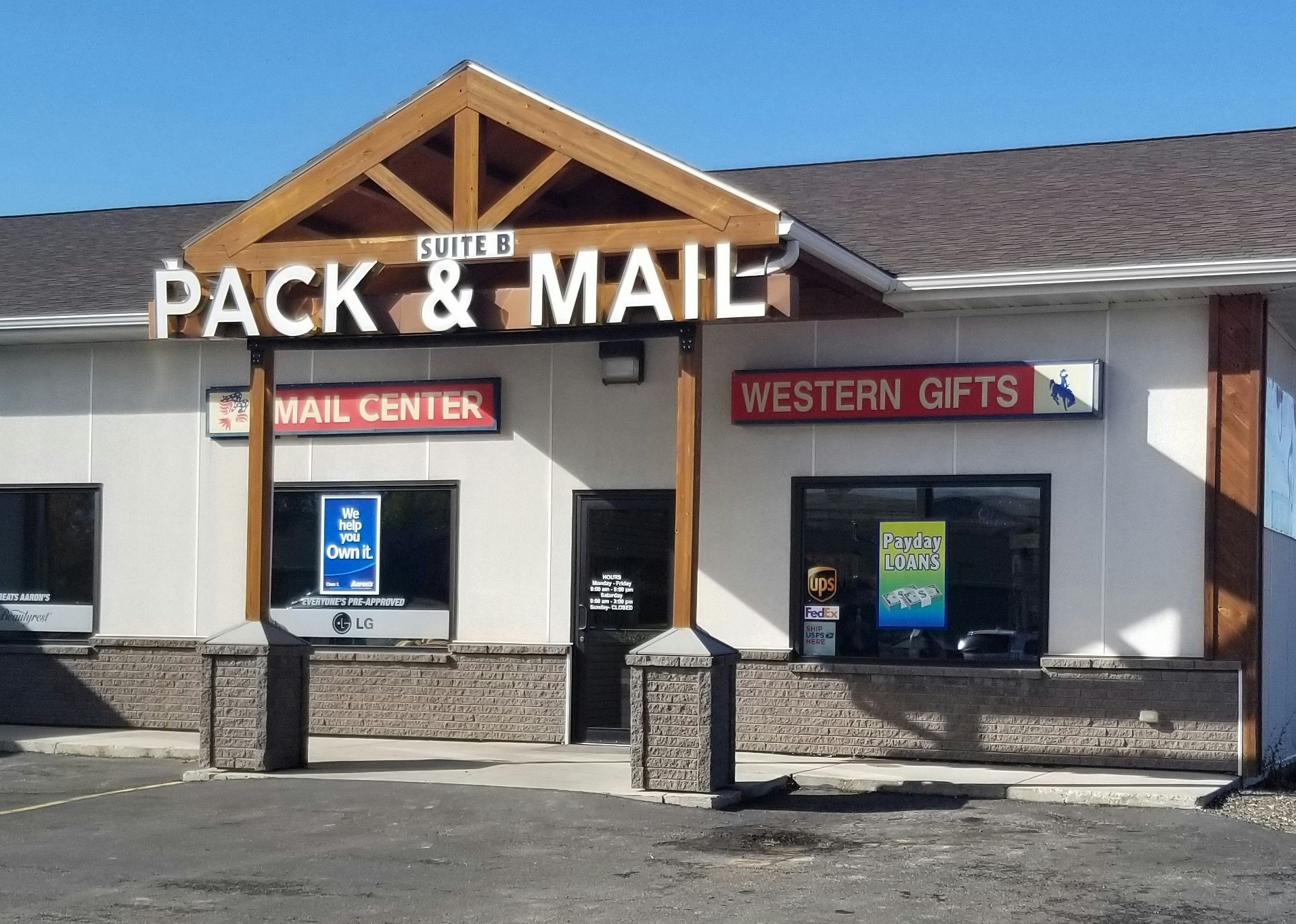 The image shows a package and mail service store with signs for a mail center, western gifts, and payday loans.