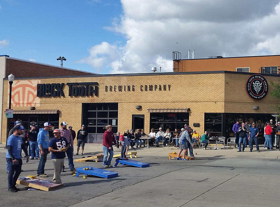 Photo of people playing cornhole
