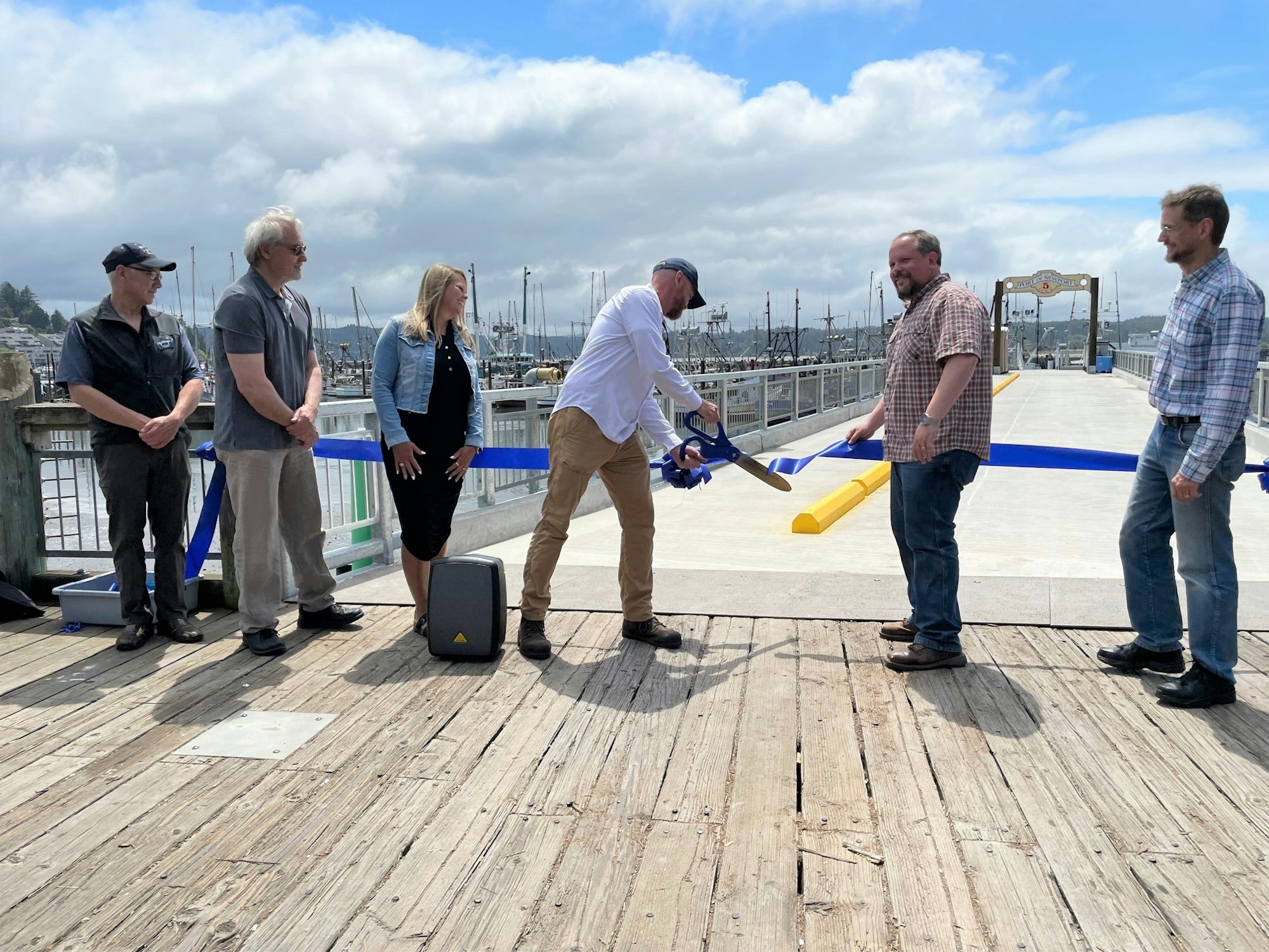 Port Commission President cuts the ribbon to officially open the pier.
