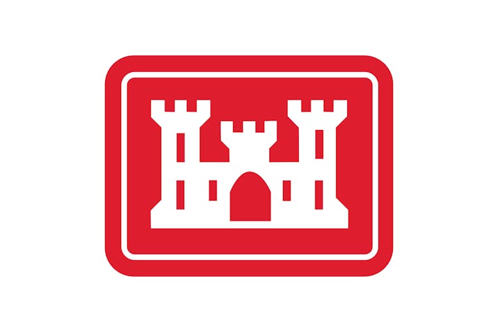 Red and white castle emblem with three towers inside a rectangular frame.
