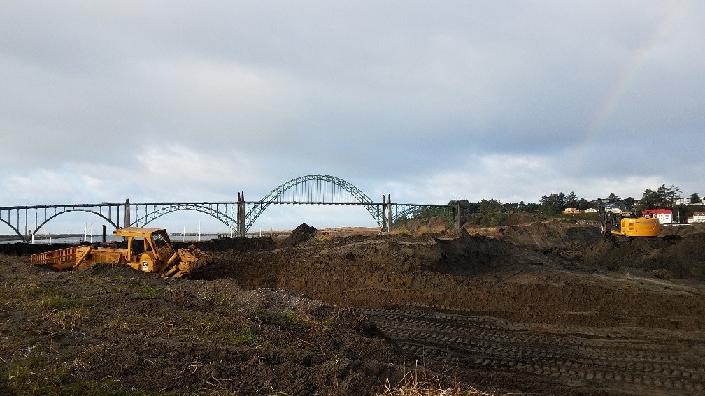 Digger moving dirt at the South Beach dredge material disposal site