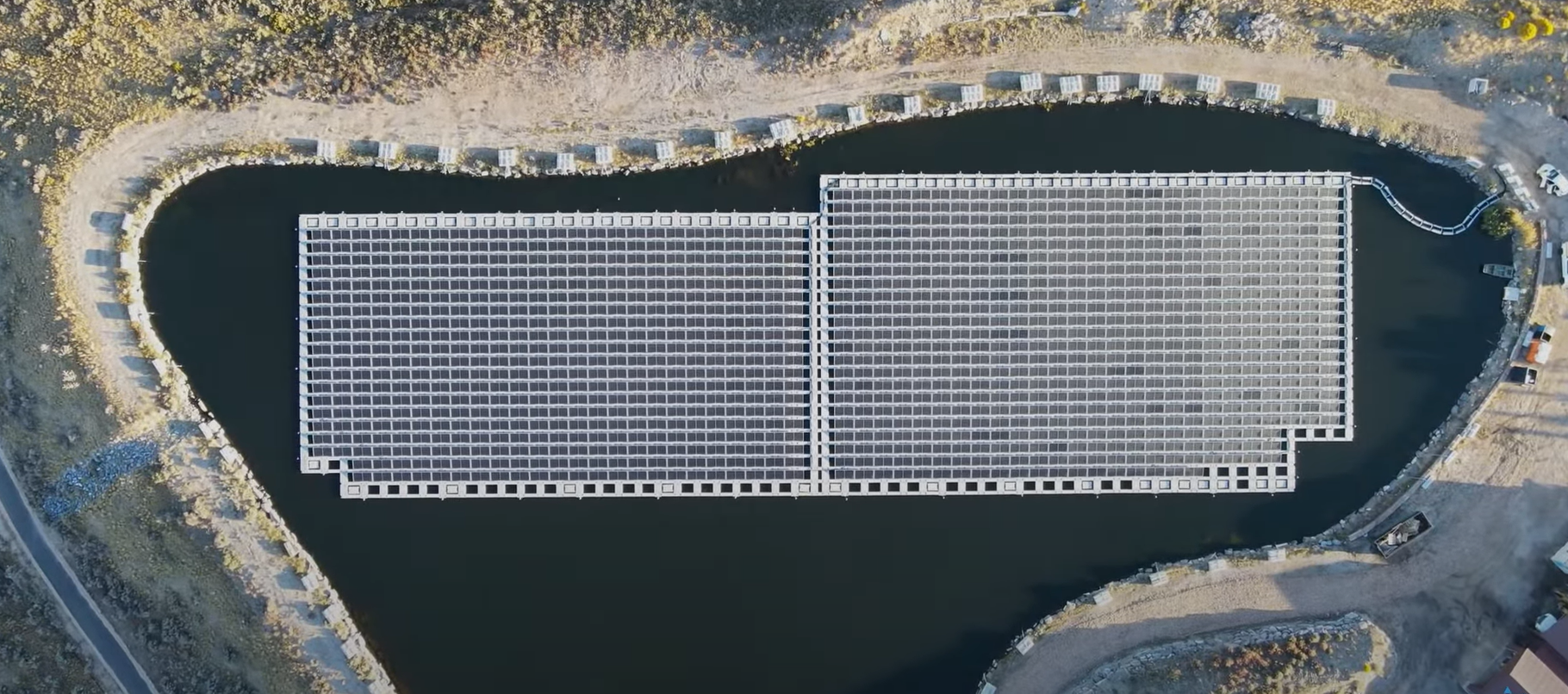 Aerial view of a floating solar panel installation on a body of water.