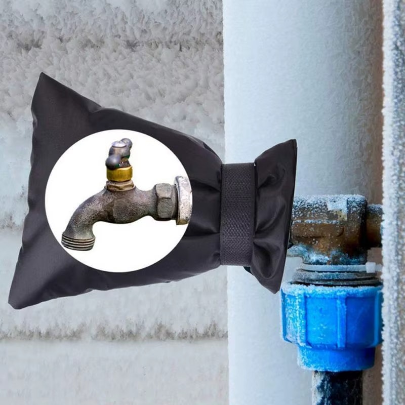A faucet is covered with an insulating cover to prevent freezing on a frosty pipe.