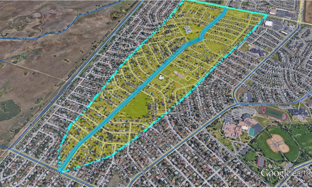Aerial view of a suburban area with highlighted region likely indicating a study area or planned development.