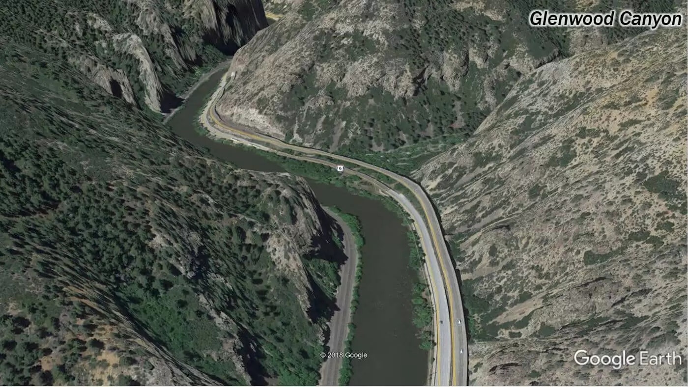 A winding road through Glenwood Canyon near a river, surrounded by rugged terrain. (Google Earth view)