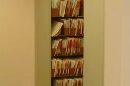 A tall bookshelf filled with numerous books.