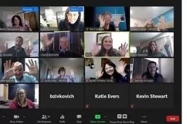 A virtual meeting with multiple participants waving.