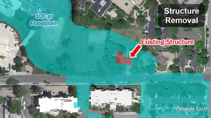 Aerial map showing a 100-year floodplain with an overlay indicating an existing structure and a proposed structure removal.
