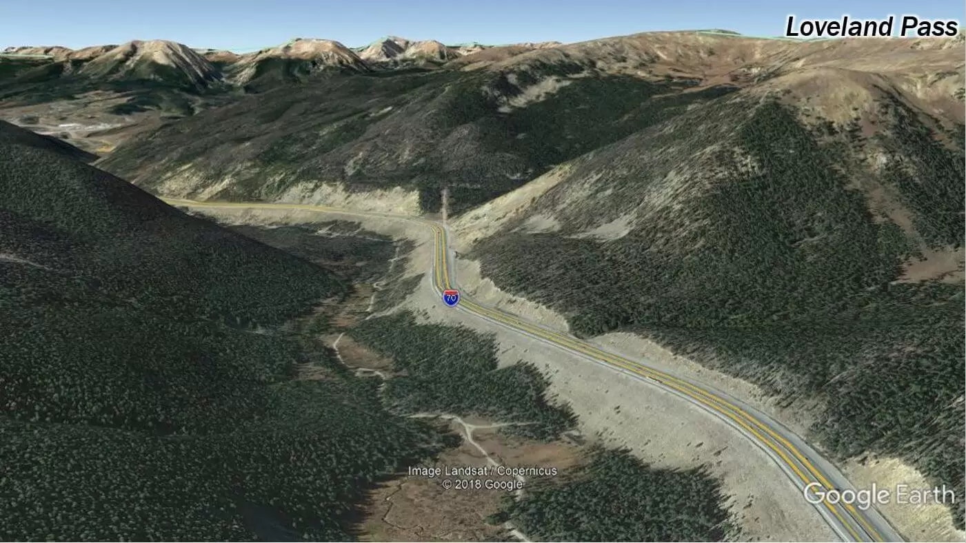 A mountain pass with a winding road, forested areas, and labeled "Loveland Pass."